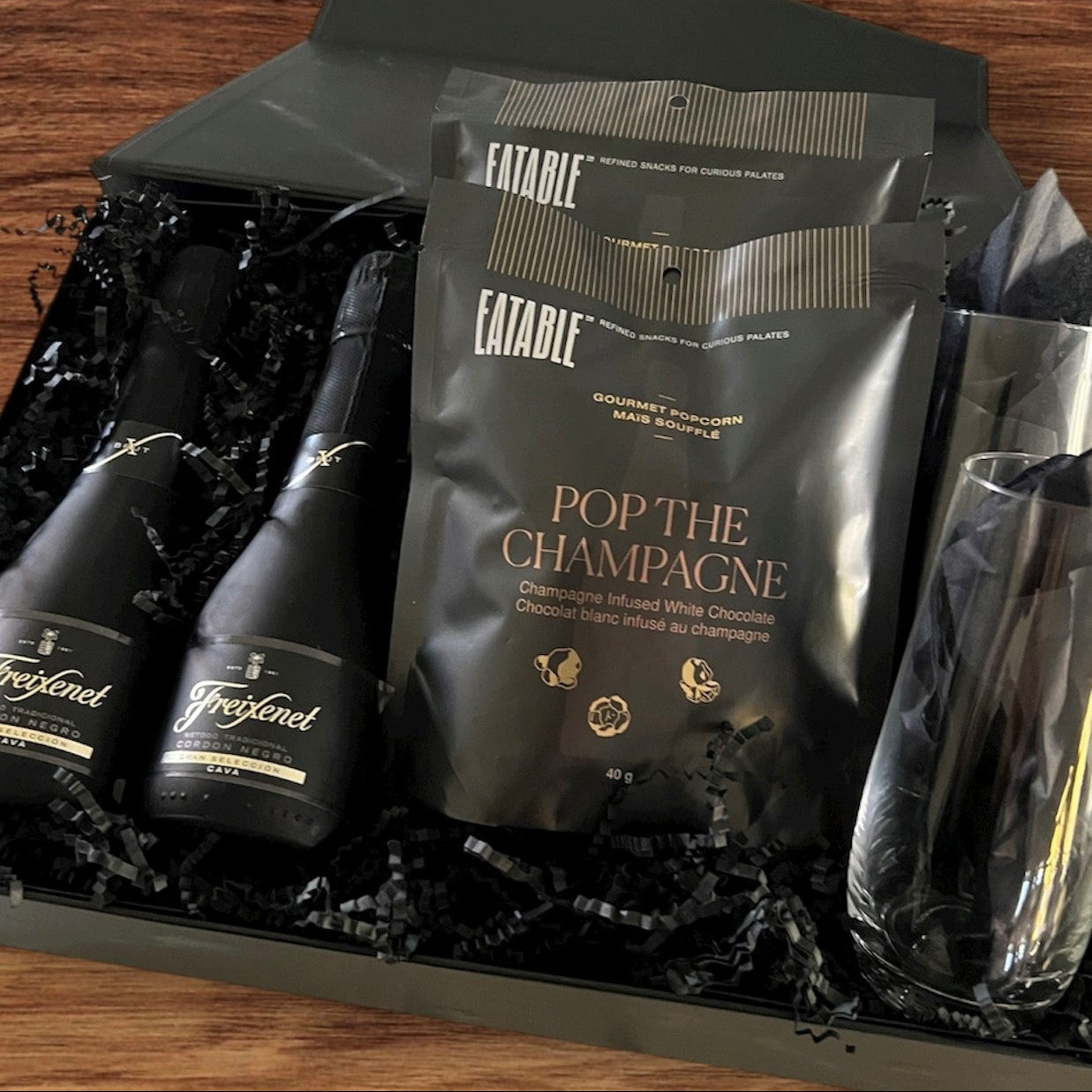 Sparkling wine by Freixfenet, tall stemless champagne glasses and champagne infused white chocolate pop corn.  Let's pop the champagne.