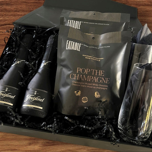 Sparkling wine by Freixfenet, tall stemless champagne glasses and champagne infused white chocolate pop corn.  Let's pop the champagne.