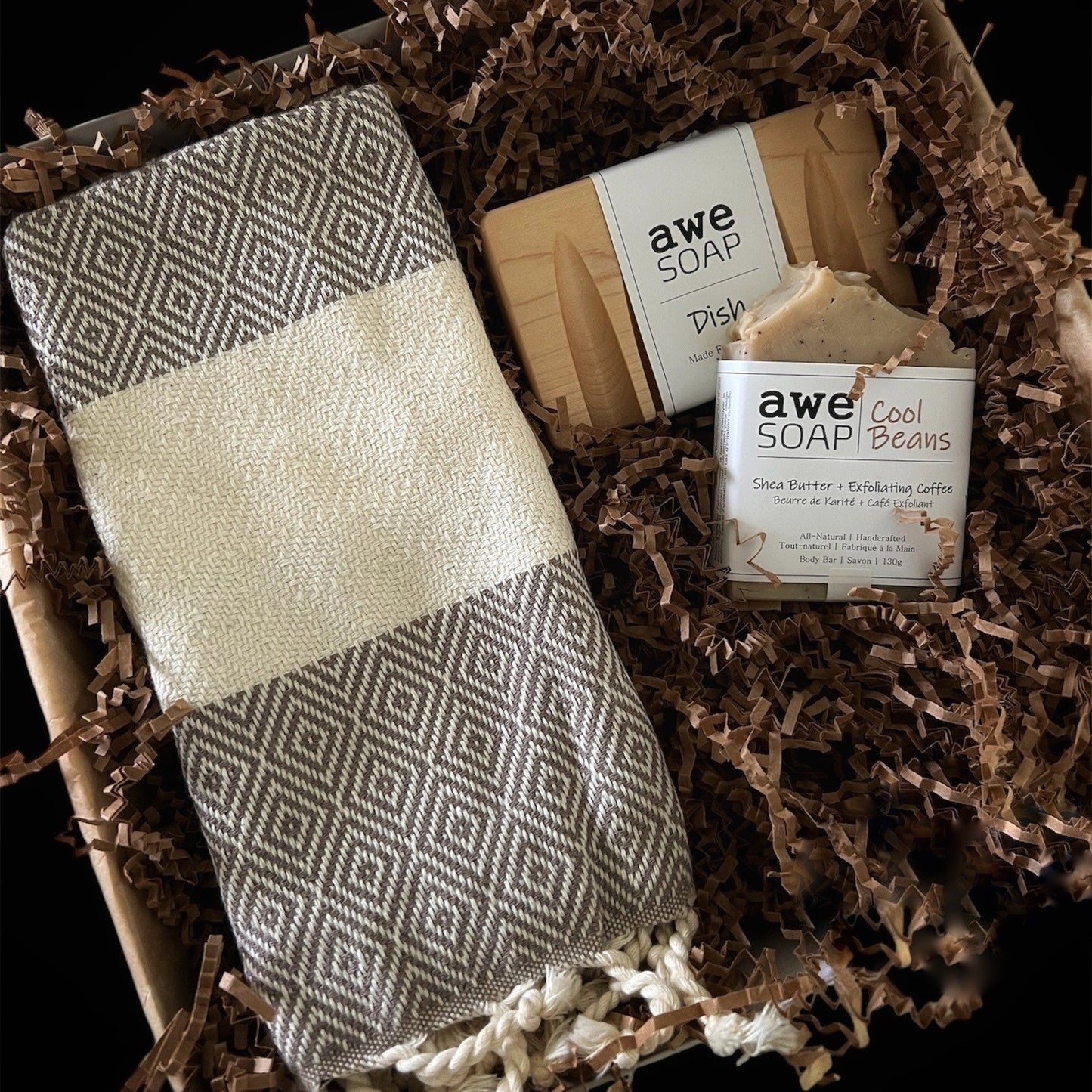 Men’s gift box with a woven Turkish towel, handcrafted dish soap, wooden soap dish and exfoliating coffee soap in neutral brown tones.